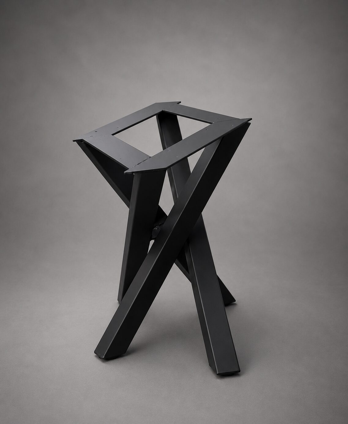 Black sculptural trestle-style steel table base