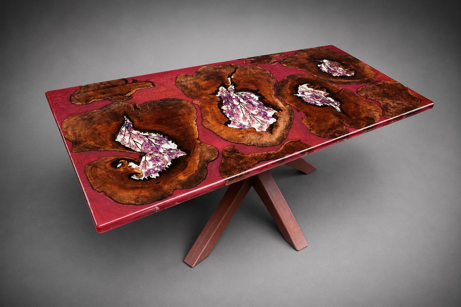 Crimson resin table with wisteria flowers cast into burl wood